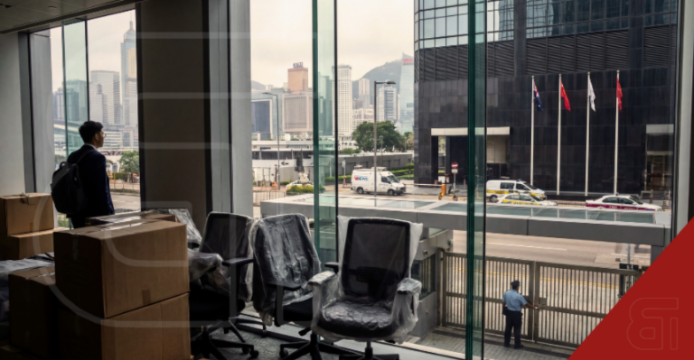 Global banking professionals in a Middle East financial district office observing a digital map with conflict warning zones, representing office closures at Citi, HSBC, and Standard Chartered.