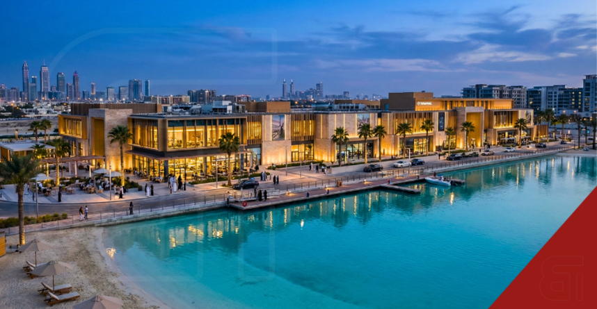 Night rendering of South Bay Mall in Dubai South, a 200,000 sq ft waterfront retail hub featuring open-air walkways along a crystal lagoon.